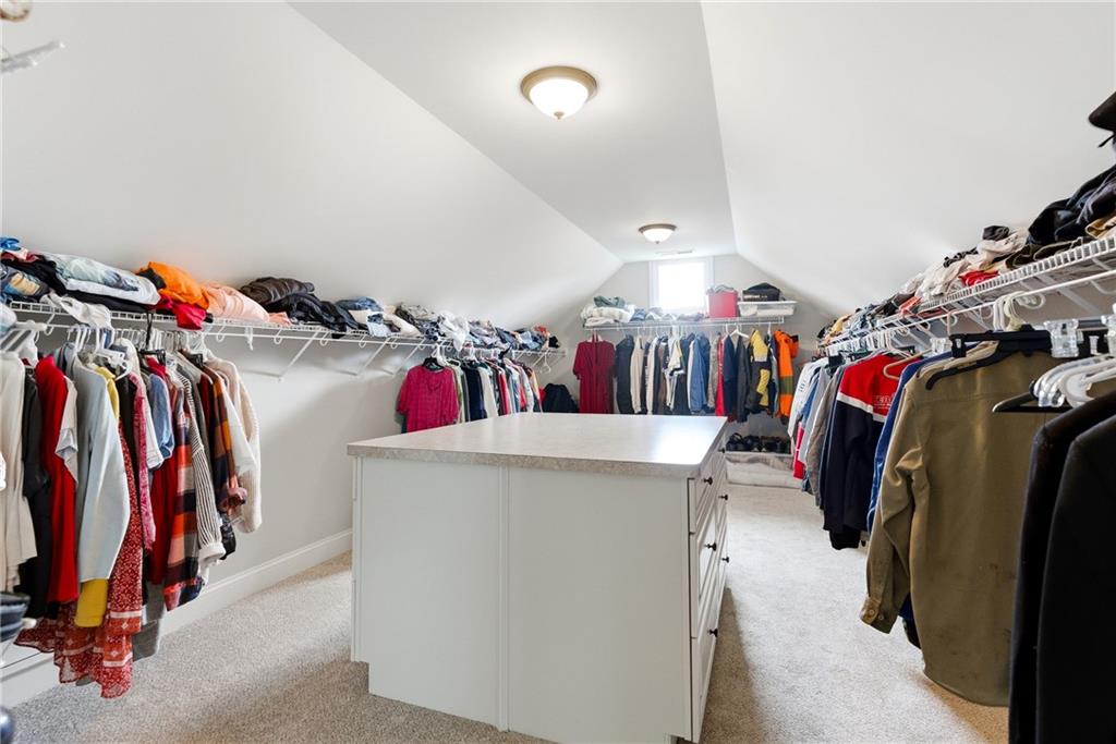 810 Ravenstone Way Canton, GA 30115 - Photo 8 of 51 a view of walk in closet with clothes and shoes