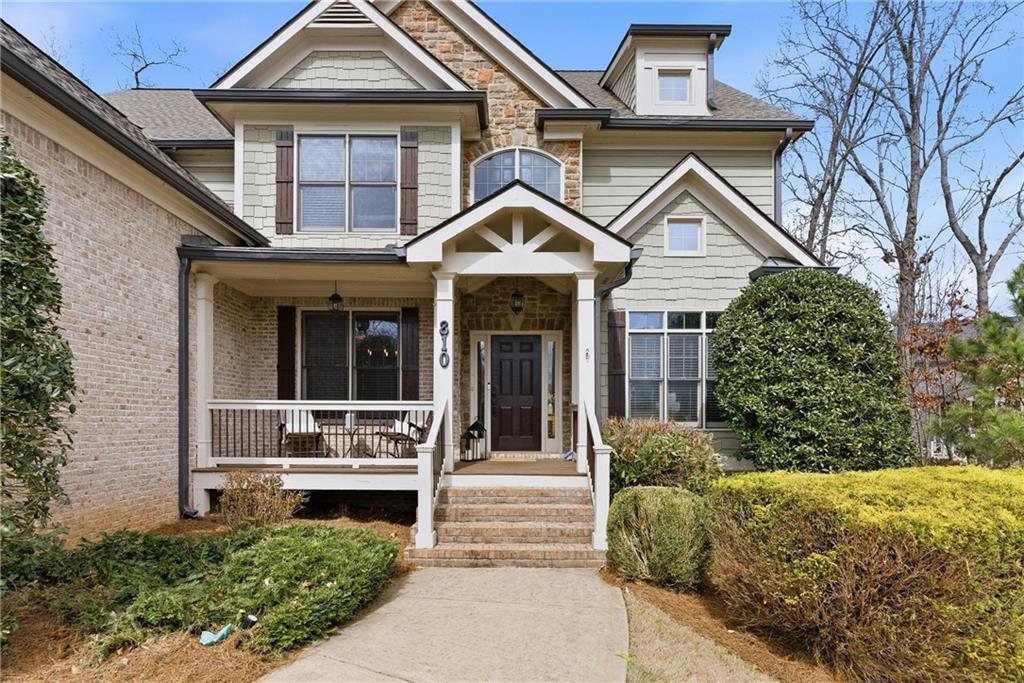 810 Ravenstone Way Canton, GA 30115 - Photo 10 of 51 a front view of a house with a garden