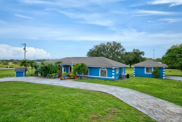 a front view of house with yard and outdoor seating