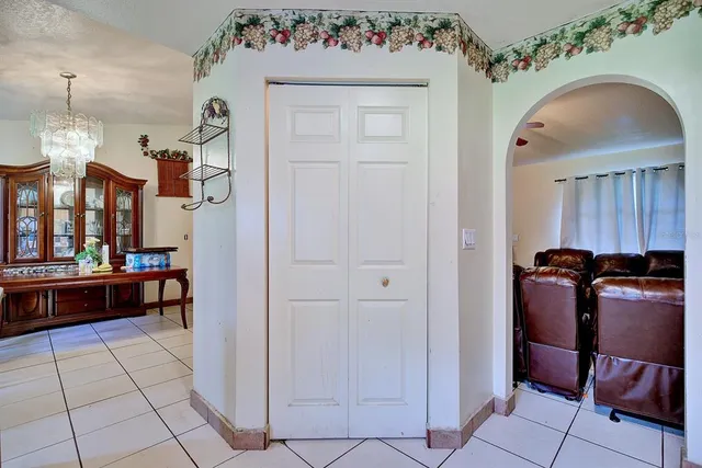 a view of a hallway and a livingroom with furniture