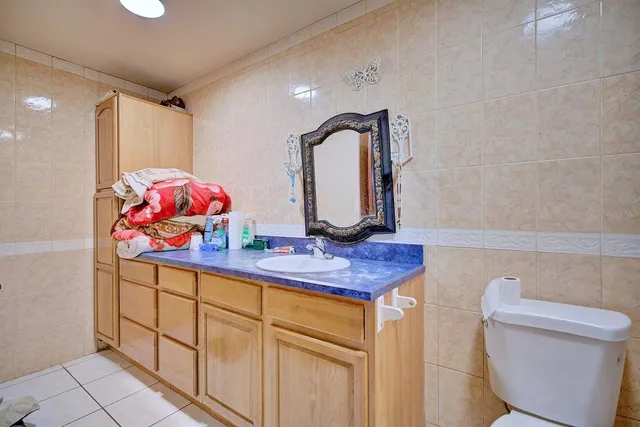a bathroom with a sink mirror vanity and toilet