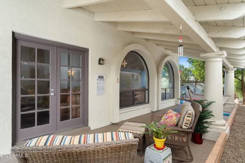 a front view of a house with outdoor seating