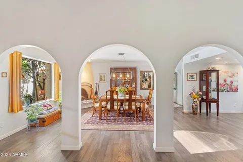 a view of a livingroom dining room and hall with furniture