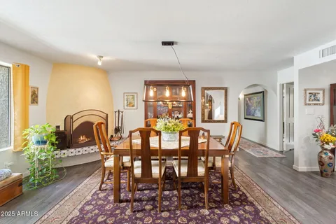 a view of a a dining room with furniture window and wooden floor