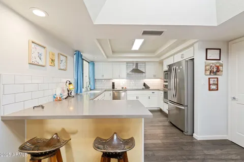 a kitchen with stainless steel appliances granite countertop a refrigerator and a sink