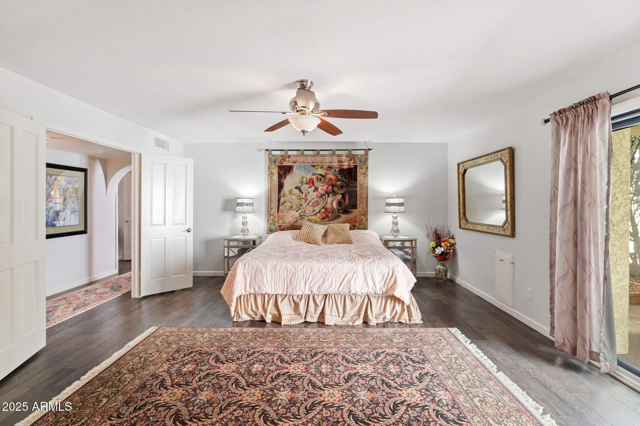 7217 North 6th Way Phoenix, AZ 85020 - Photo 27 of 43 a bedroom with a large bed and a chandelier