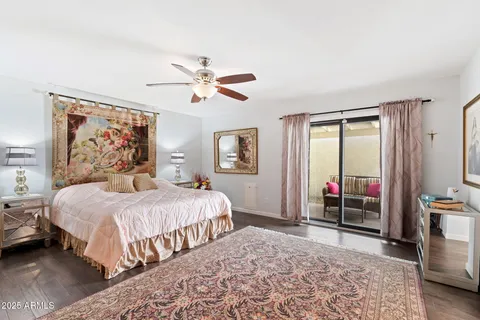 a bedroom with bed and wooden floor