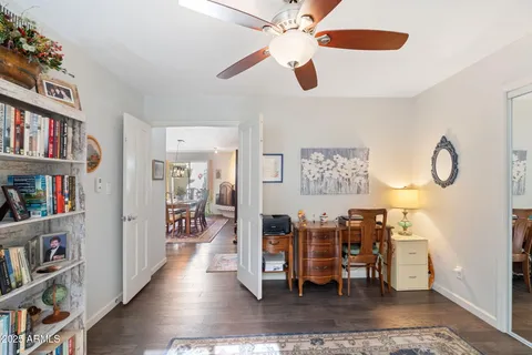 a view of a workspace with furniture and wooden floor
