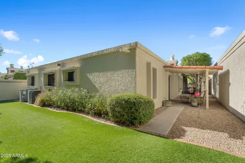 a view of a house with backyard and porch