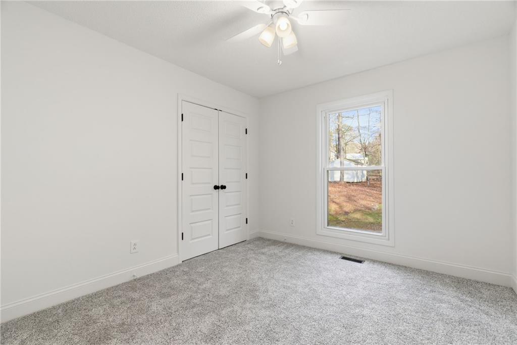 3447 Dry Creek Road Marietta, GA 30062 - Photo 17 of 50 an empty room with windows and closet
