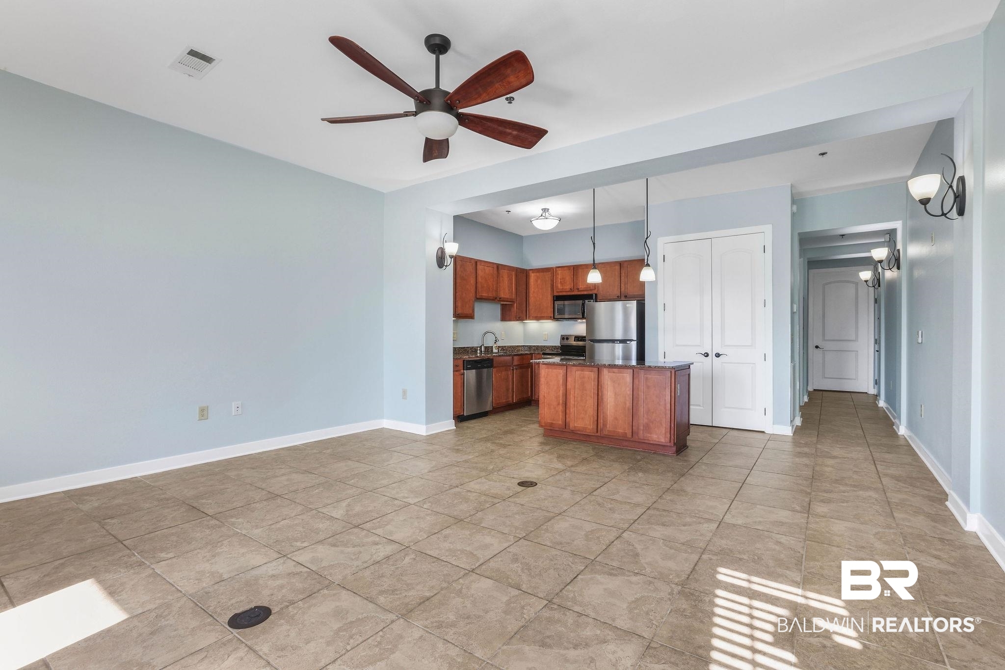 1430 Regency Road, Unit B302 Gulf Shores, AL 36542 - Photo 7 of 24 Kitchen featuring visible vents, a kitchen island, baseboards, appliances with stainless steel finishes, and a ceiling fan