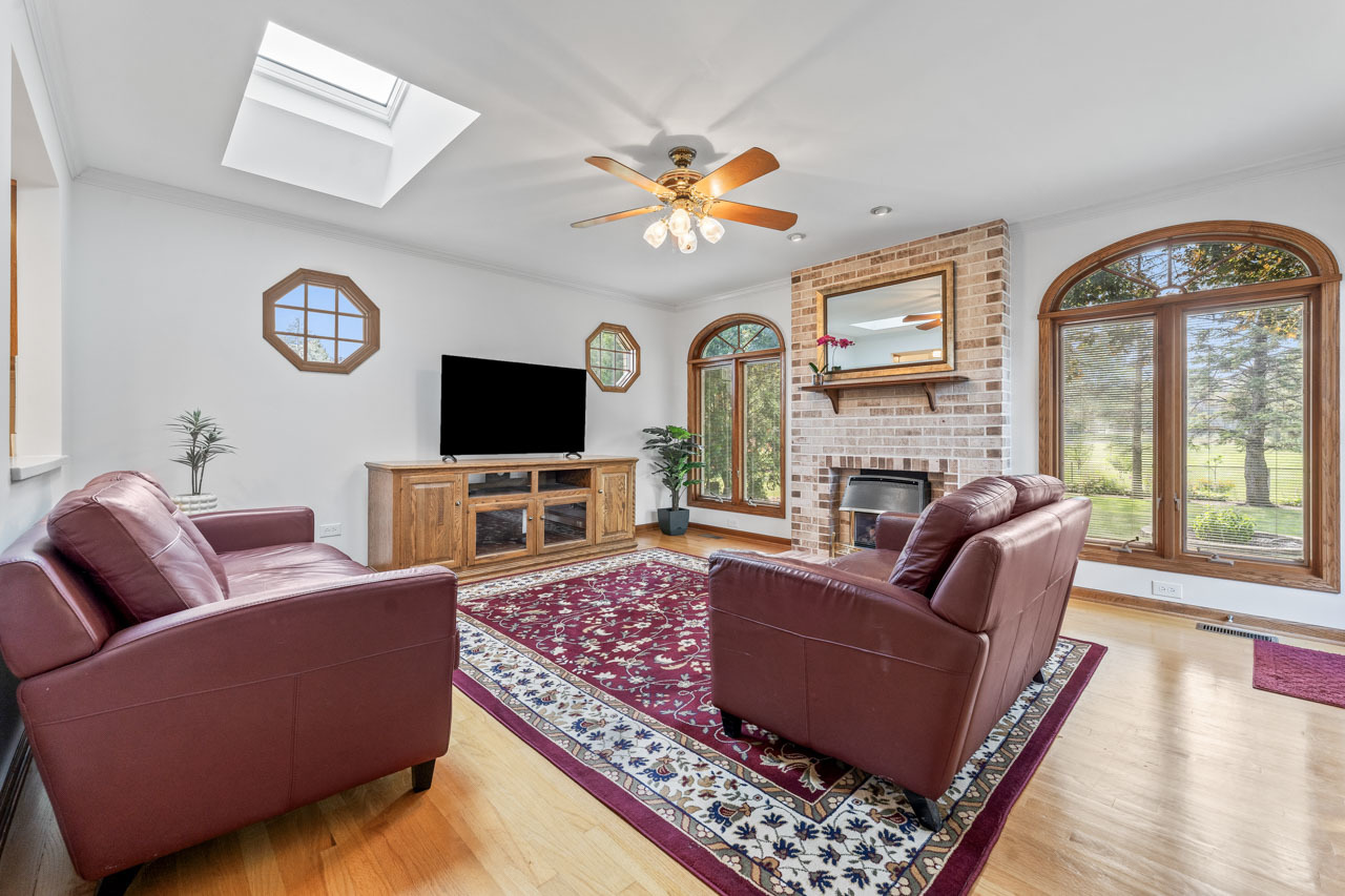 302 North Marcella Road Mount Prospect, IL 60056 - Photo 8 of 21 a living room with fireplace furniture and a flat screen tv