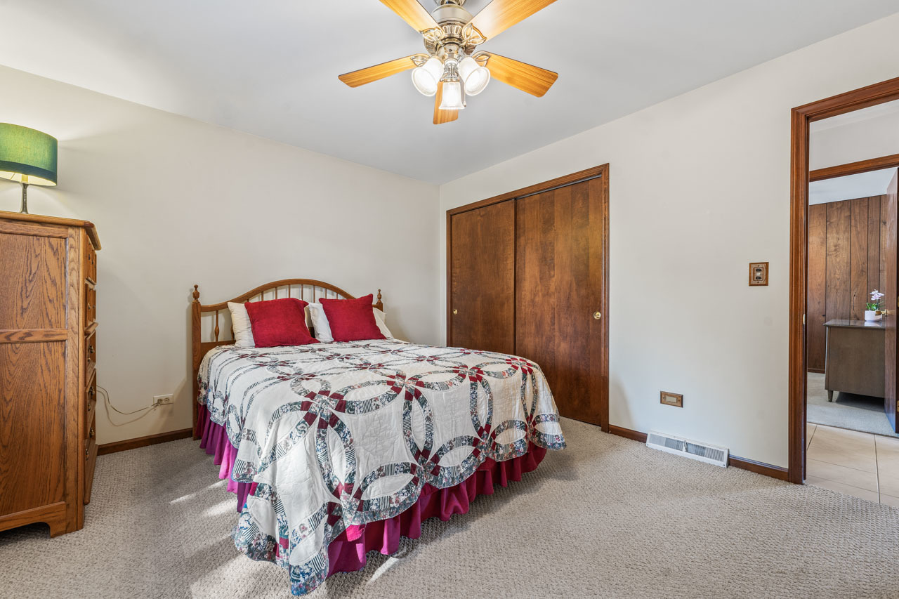 302 North Marcella Road Mount Prospect, IL 60056 - Photo 9 of 21 a bedroom with a bed and a chandelier