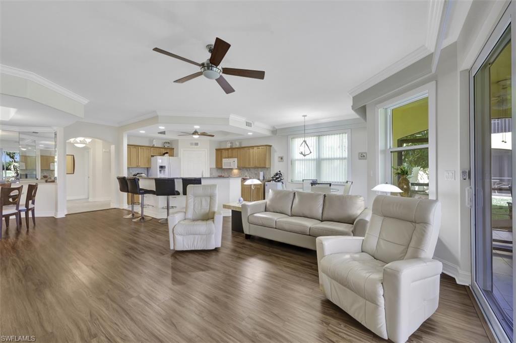 1276 Rialto Way, Unit 101 Naples, FL 34114 - Photo 1 of 37 a living room with furniture and a large window