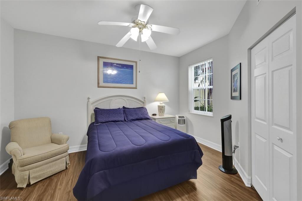 1276 Rialto Way, Unit 101 Naples, FL 34114 - Photo 16 of 37 a bedroom with a bed and a couch