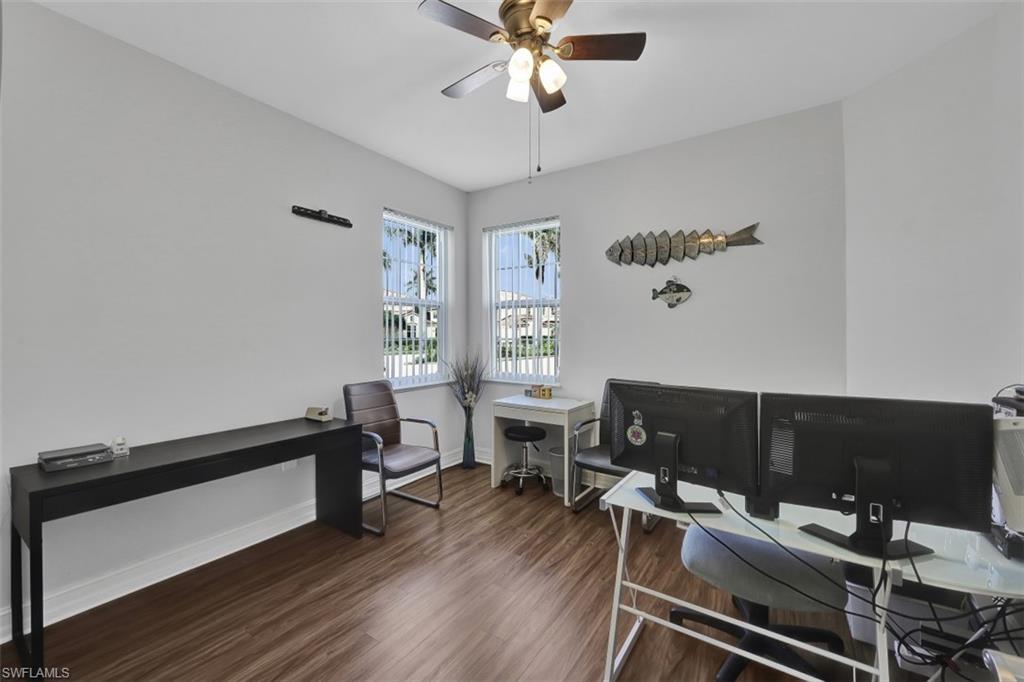 1276 Rialto Way, Unit 101 Naples, FL 34114 - Photo 18 of 37 a view of a workspace with furniture and a window