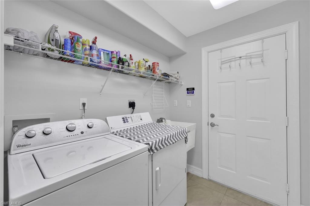 1276 Rialto Way, Unit 101 Naples, FL 34114 - Photo 19 of 37 a utility room with dryer and washer