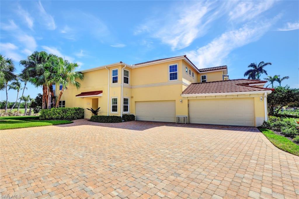 1276 Rialto Way, Unit 101 Naples, FL 34114 - Photo 21 of 37 a view of a house with a yard