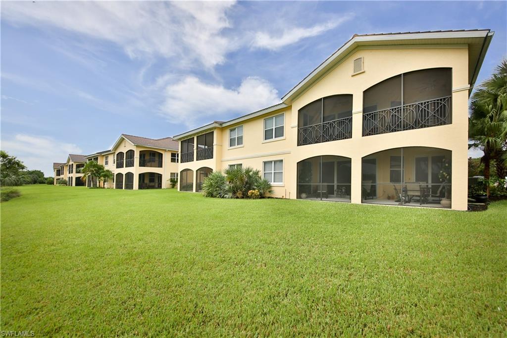 1276 Rialto Way, Unit 101 Naples, FL 34114 - Photo 22 of 37 a view of a yard in front of a house