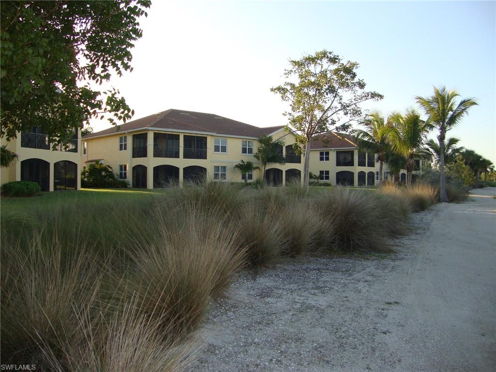 1276 Rialto Way, Unit 101 Naples, FL 34114 - Photo 23 of 37 a view of a yard in front of house