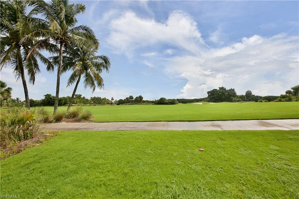 1276 Rialto Way, Unit 101 Naples, FL 34114 - Photo 26 of 37 a view of yard and ocean