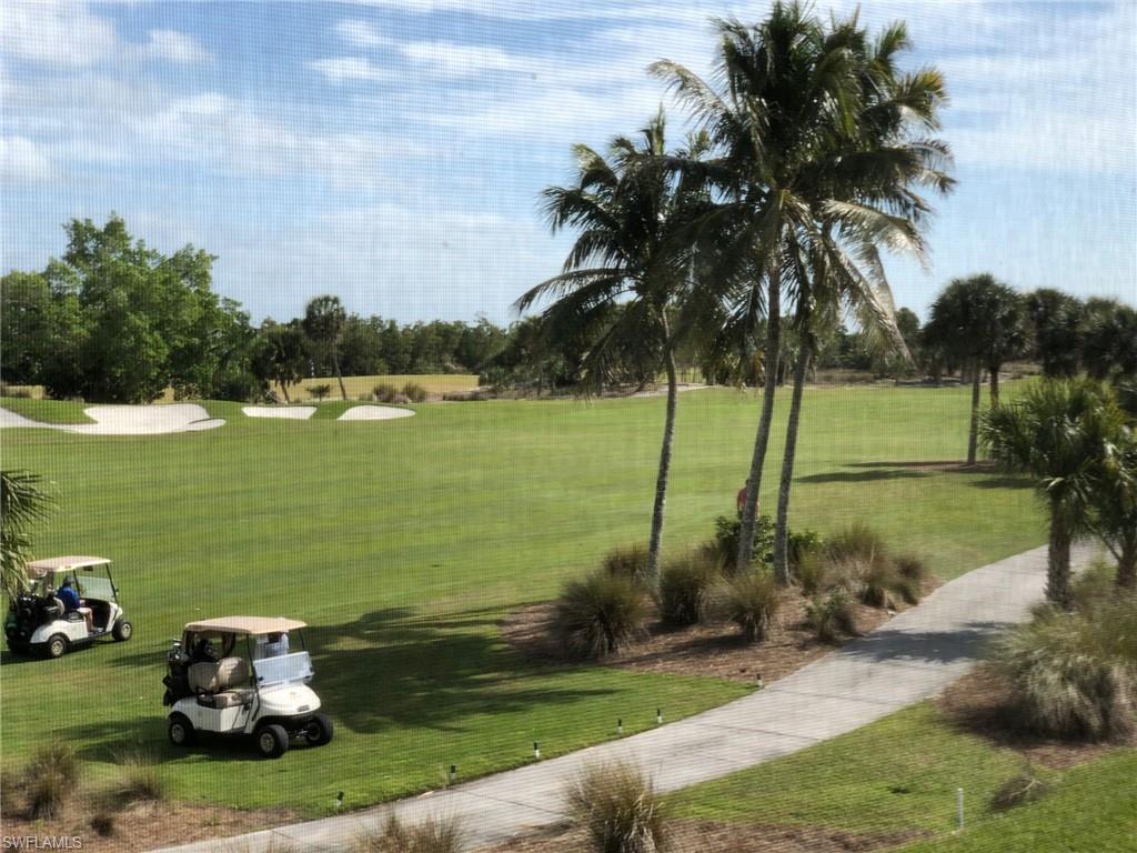 1276 Rialto Way, Unit 101 Naples, FL 34114 - Photo 30 of 37 a lake view with a garden