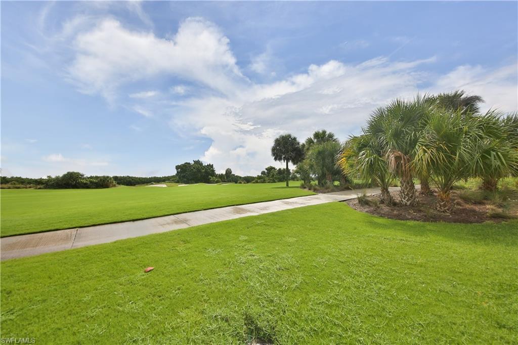 1276 Rialto Way, Unit 101 Naples, FL 34114 - Photo 31 of 37 a view of an outdoor space and a yard