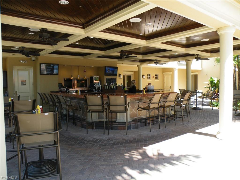 1276 Rialto Way, Unit 101 Naples, FL 34114 - Photo 35 of 37 a view of a dining room with furniture