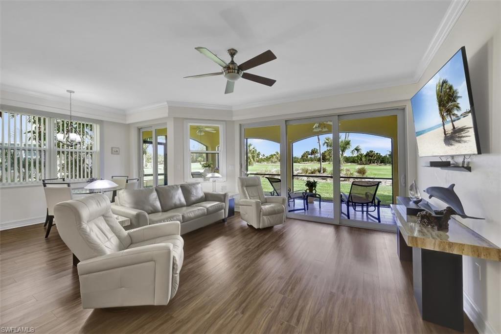 1276 Rialto Way, Unit 101 Naples, FL 34114 - Photo 5 of 37 a living room with furniture and a large window