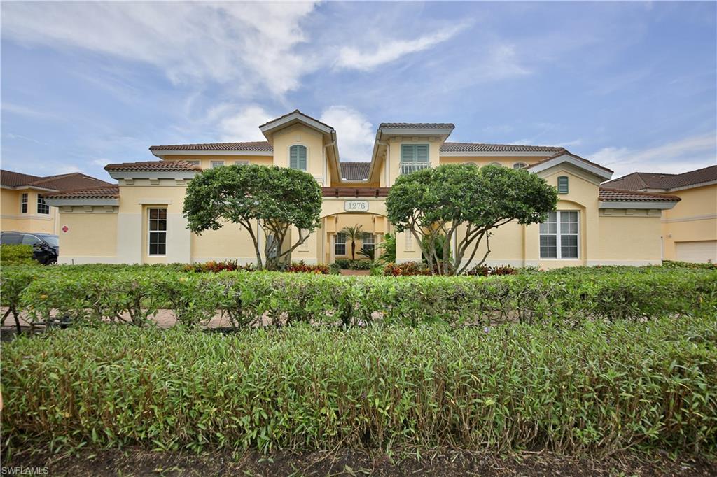 1276 Rialto Way, Unit 101 Naples, FL 34114 - Photo 6 of 37 a front view of house with a yard
