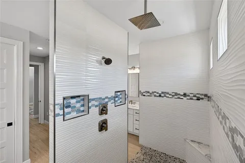 a bathroom with a sink a toilet and shower