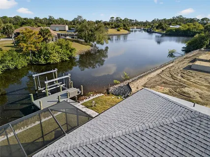 an aerial view of a house with lake view
