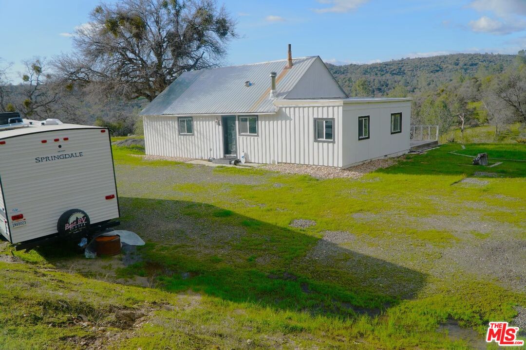 4132 Usona Road Mariposa, CA 95338 - Photo 19 of 26 a aerial view of a house with swimming pool and a yard