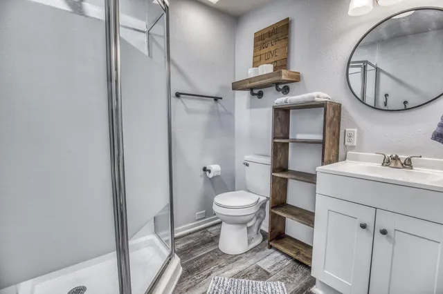 a bathroom with a sink toilet and a mirror