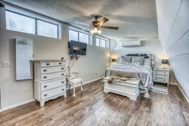 a bedroom with furniture and a chandelier