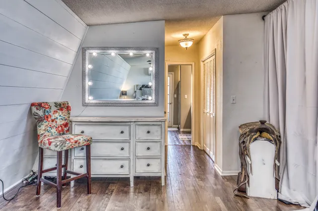 a view of a livingroom with wooden floor and a dining table
