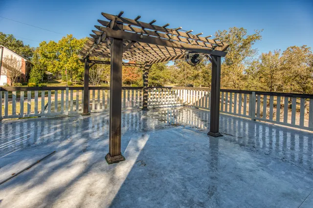 a view of a porch with a floor to ceiling window next to a yard
