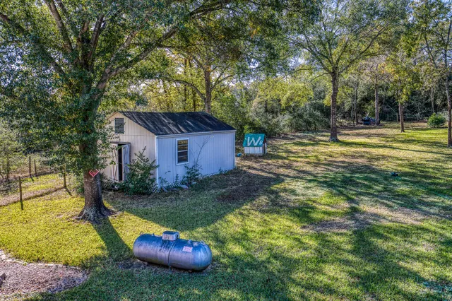 a view of a backyard with swimming pool