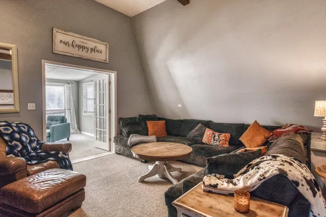 a living room with furniture and a potted plant
