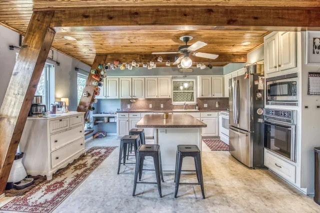 a kitchen with a table and chairs in it