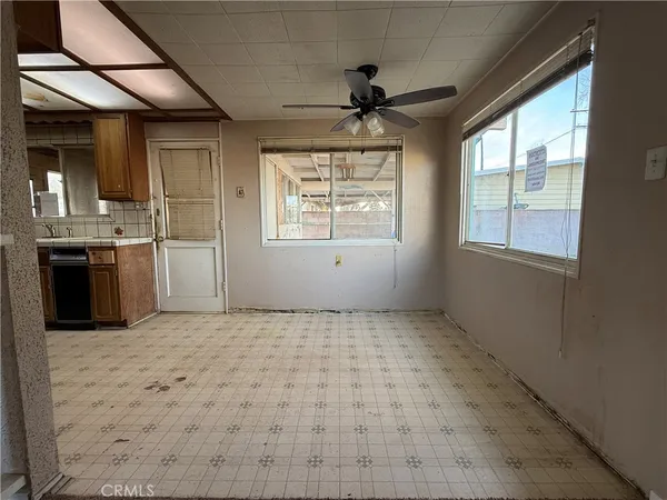 a kitchen with stainless steel appliances granite countertop a stove top oven a sink and a refrigerator
