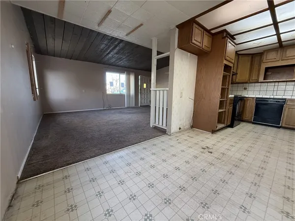 an empty room with chandelier fan