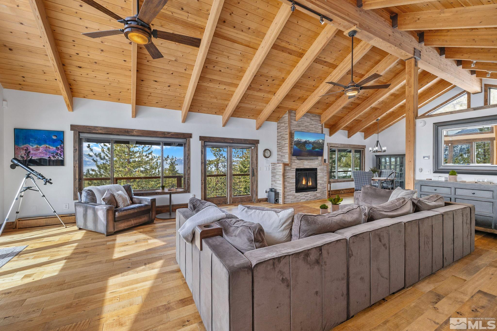 a living room with furniture a flat screen tv and a large window
