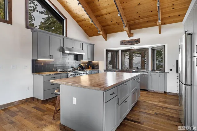 a kitchen with stainless steel appliances granite countertop a sink a counter top space cabinets and stainless steel appliances