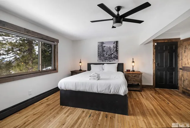 a bedroom with a bed and a large window