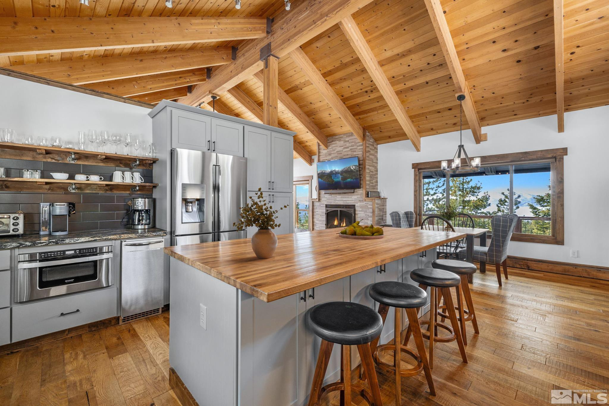 520 Laurel Lane Stateline, NV 89449 - Photo 9 of 29 a kitchen with stainless steel appliances granite countertop a kitchen island a stove a table and chairs