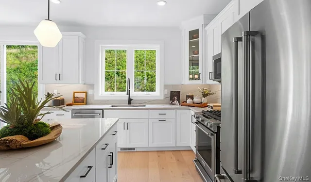 a kitchen with a sink stove and cabinets