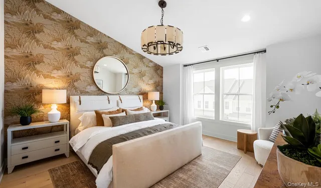 a bedroom with bed and a large window