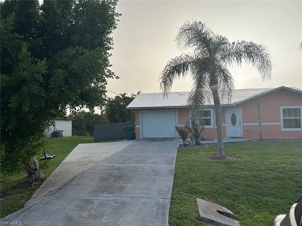 2049 50th Street Southwest Naples, FL 34116 - Photo 1 of 7 a front view of house with yard and green space