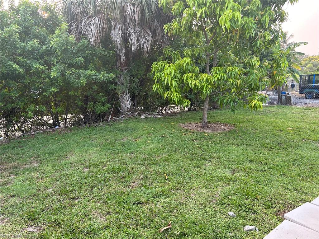 2049 50th Street Southwest Naples, FL 34116 - Photo 5 of 7 a green field with lots of trees